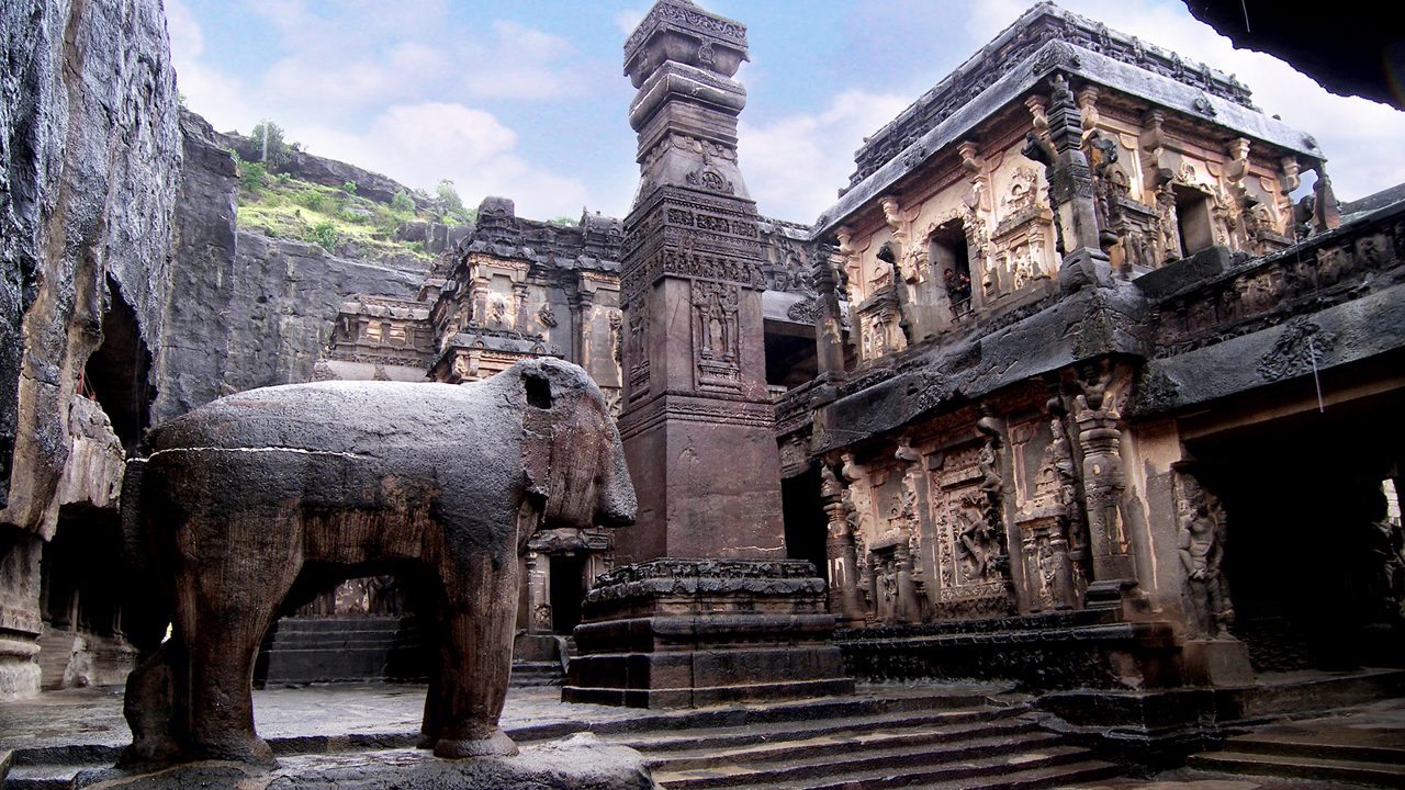 Kailasa Temple courtyard at Ellora Caves — monolithic elephant and victory pillar
